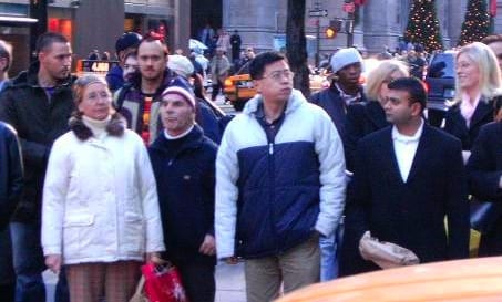 People on a city street waiting to cross.