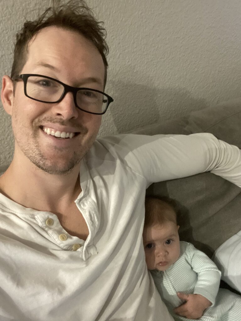A photo of Casey and his newborn.