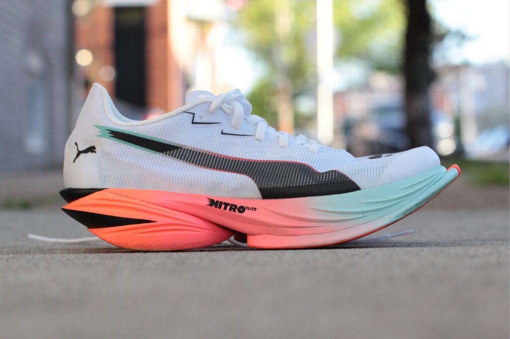 A carbon-plated racing shoe photographed in profile.